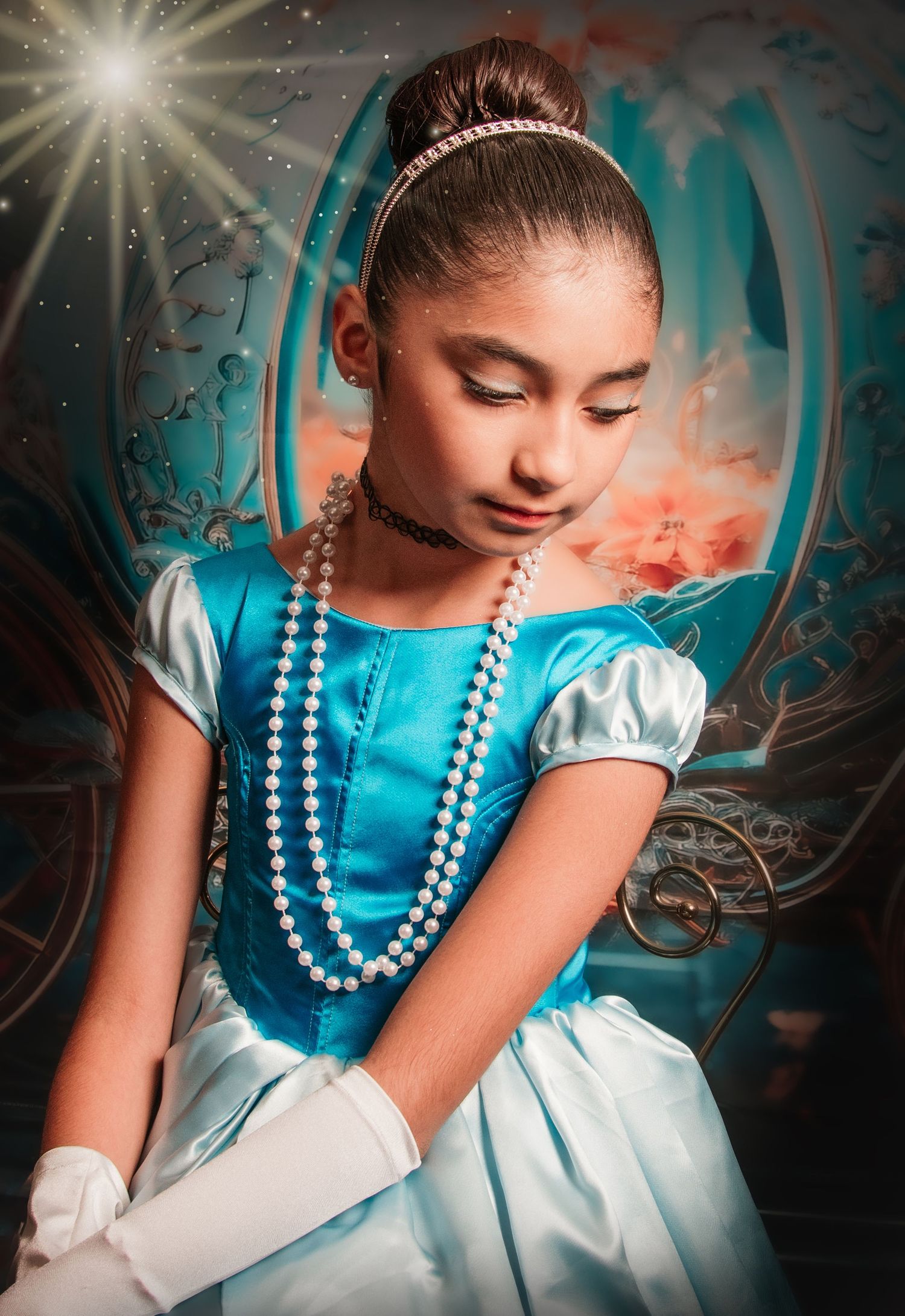 Young girl dressed as Cinderella in blue gown, white gloves, pearl necklace, and tiara poses gracefully.