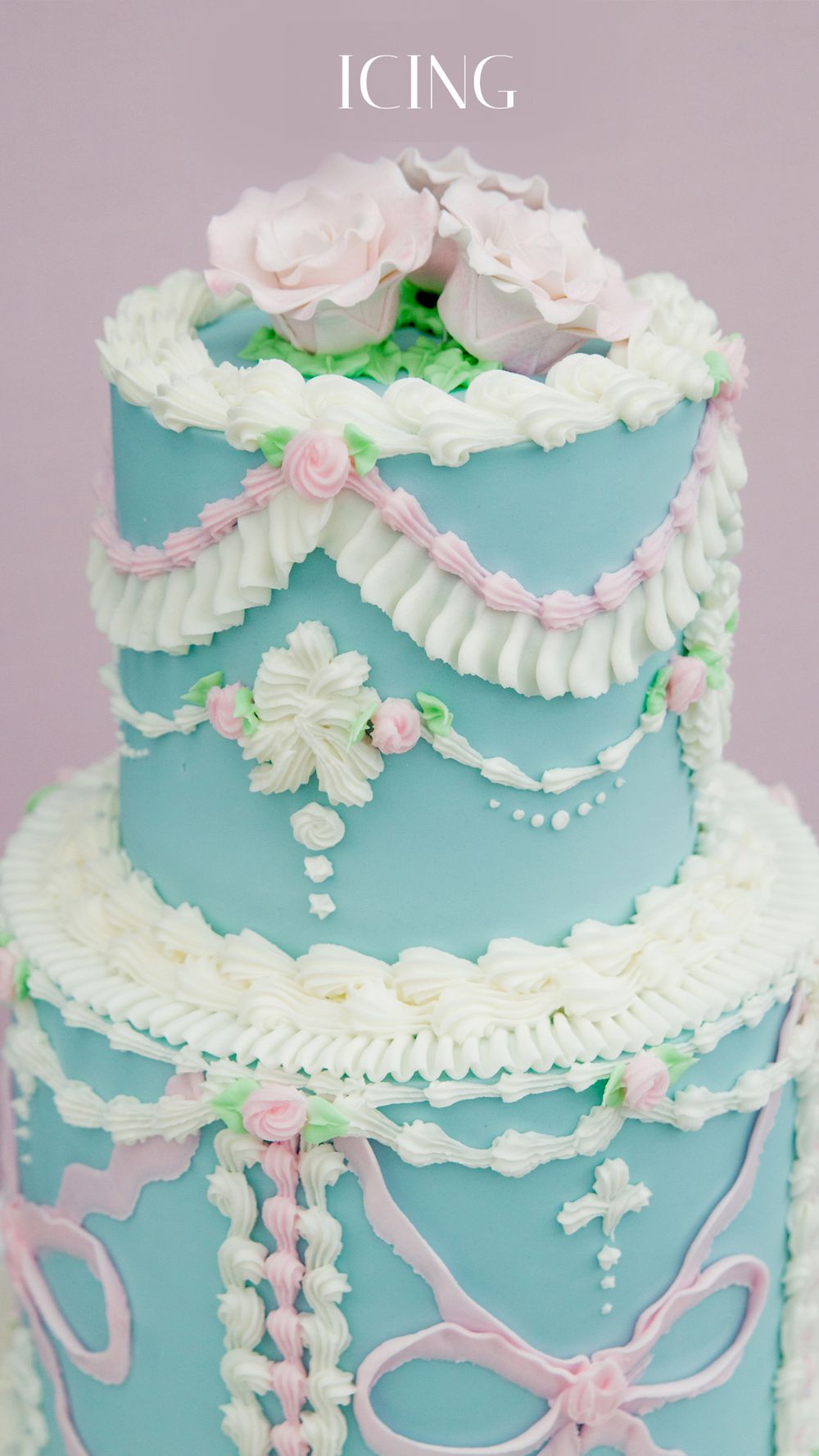 Elegant three-tier teal cake with white ruffles, pink roses, bow details, and intricate piped decorations.