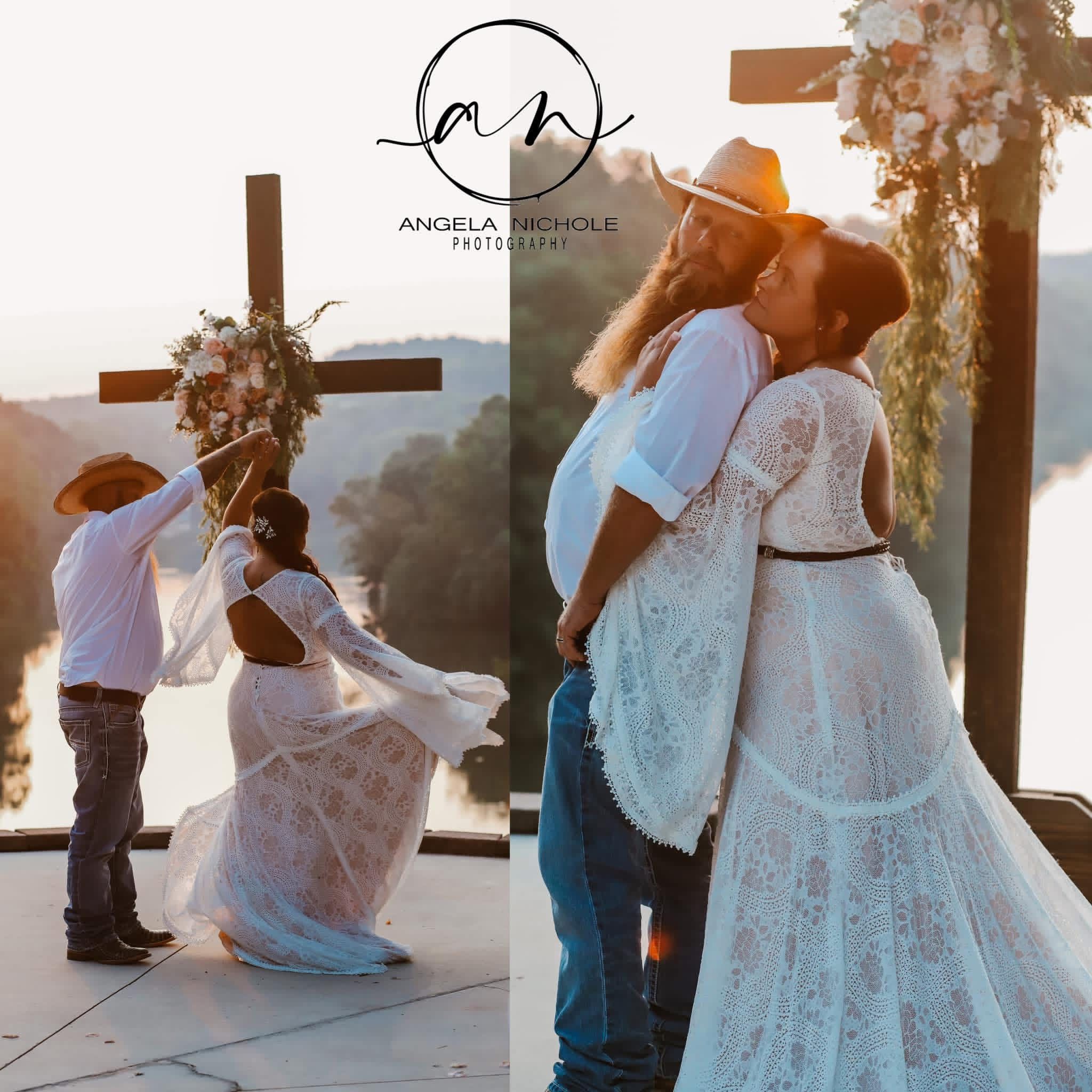 Outdoor wedding ceremony with bride in lace gown and groom in cowboy hat, exchanging vows near a wooden cross at sunset.