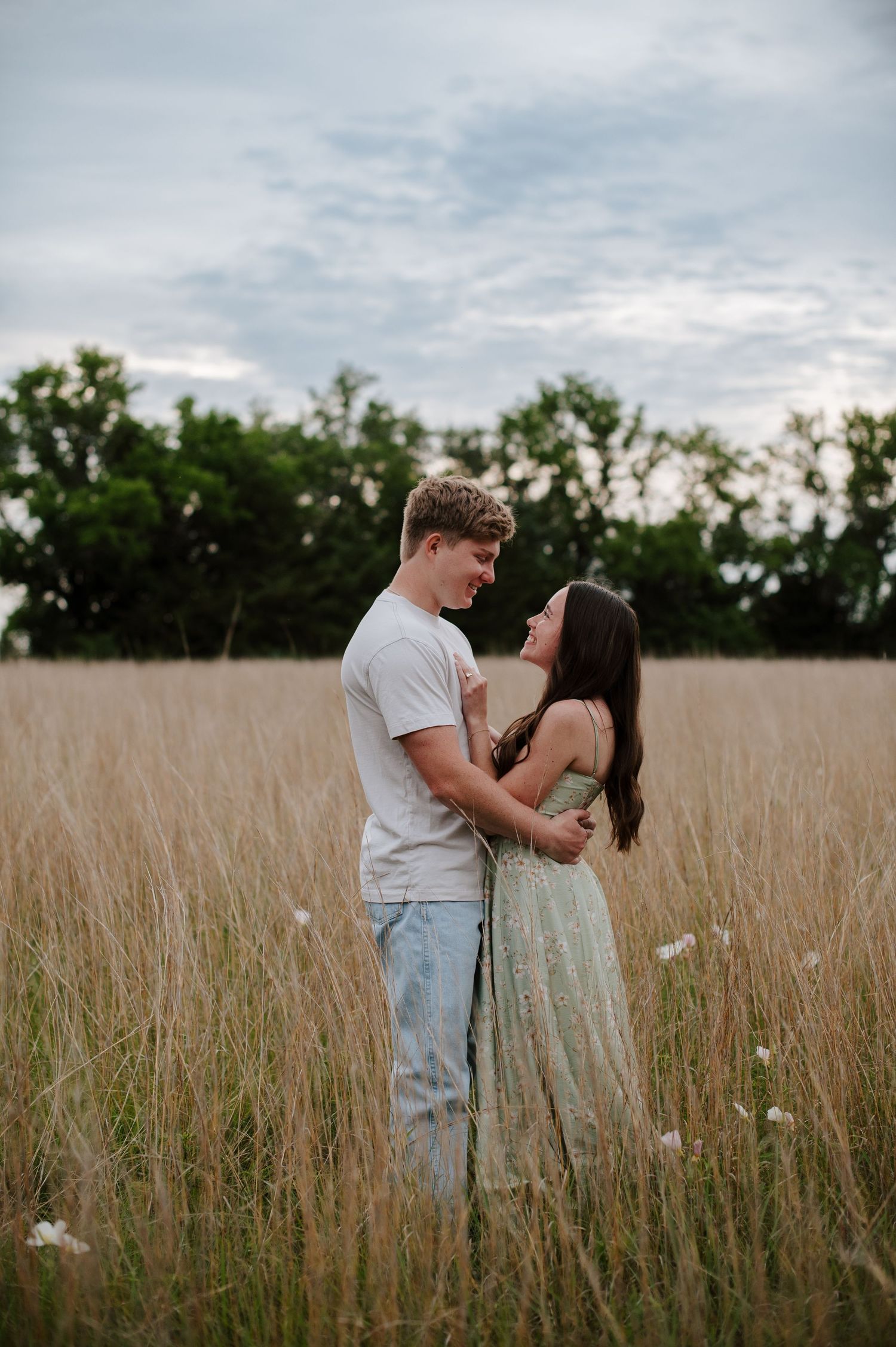 Wichita KS outdoor engagement photos in nature location Andover, couple photos in field with flowers, small elopement wedding photographer