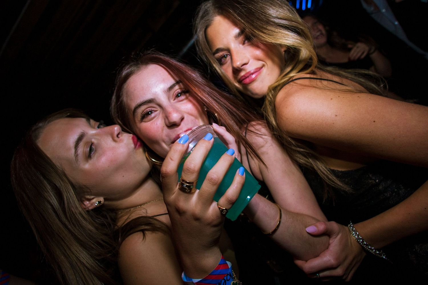 A party girl drinks at an LA nightclub.