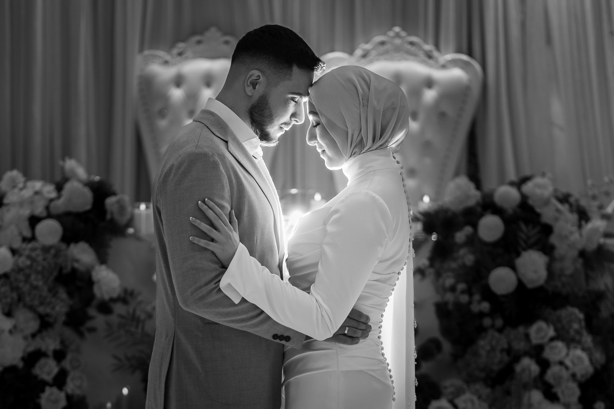 Black and white wedding photograph capturing an intimate moment during the celebration.