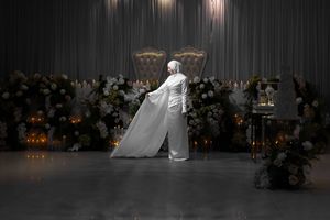 Elegant wedding reception venue decorated with white floral arrangements and soft lighting creating a romantic atmosphere.
