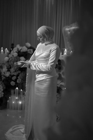 Atmospheric black and white photos of a dance performance in an elegant venue with dramatic lighting.