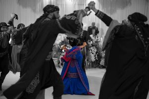 Wedding celebration with guests dancing and enjoying festivities on the dance floor.