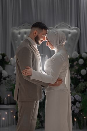 Artistic wedding dance sequence captured in soft lighting with floral backdrop.