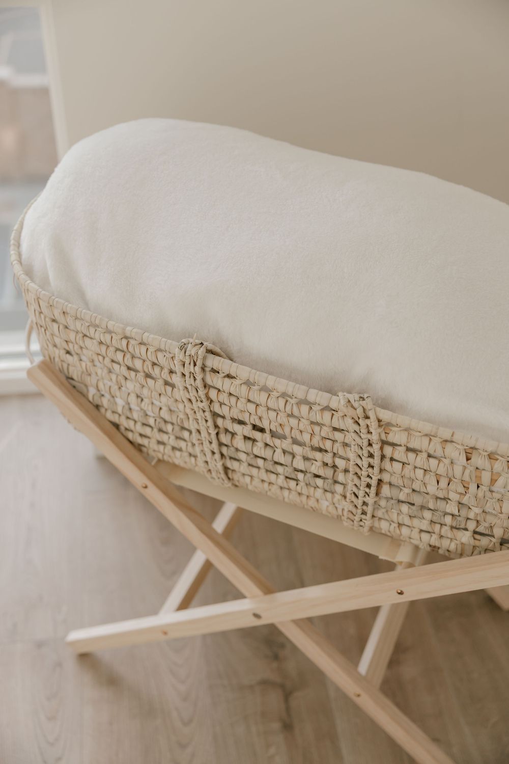 Macrame trimmed cushion on wooden folding base creates a cozy boho-style seat or bench detail.