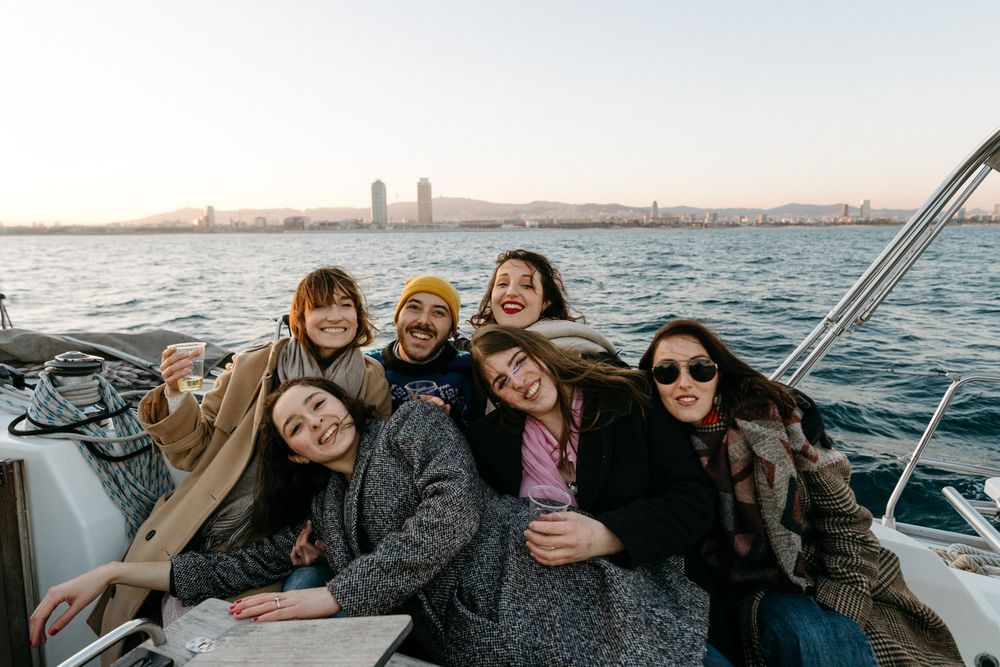 Friends enjoying a relaxing day together on a sailboat at sea.