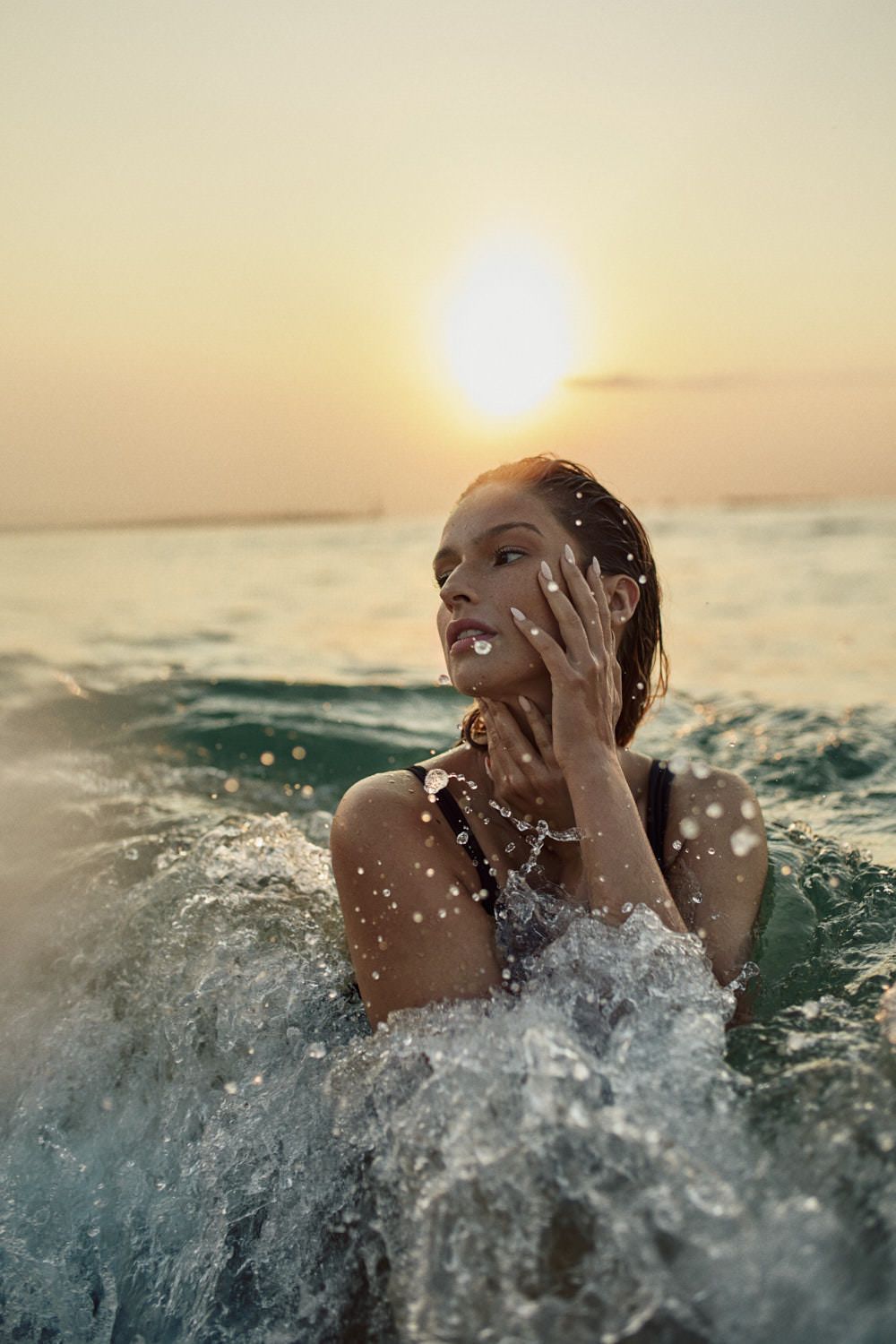 Dynamic water splash portrait series during golden sunset at beach.