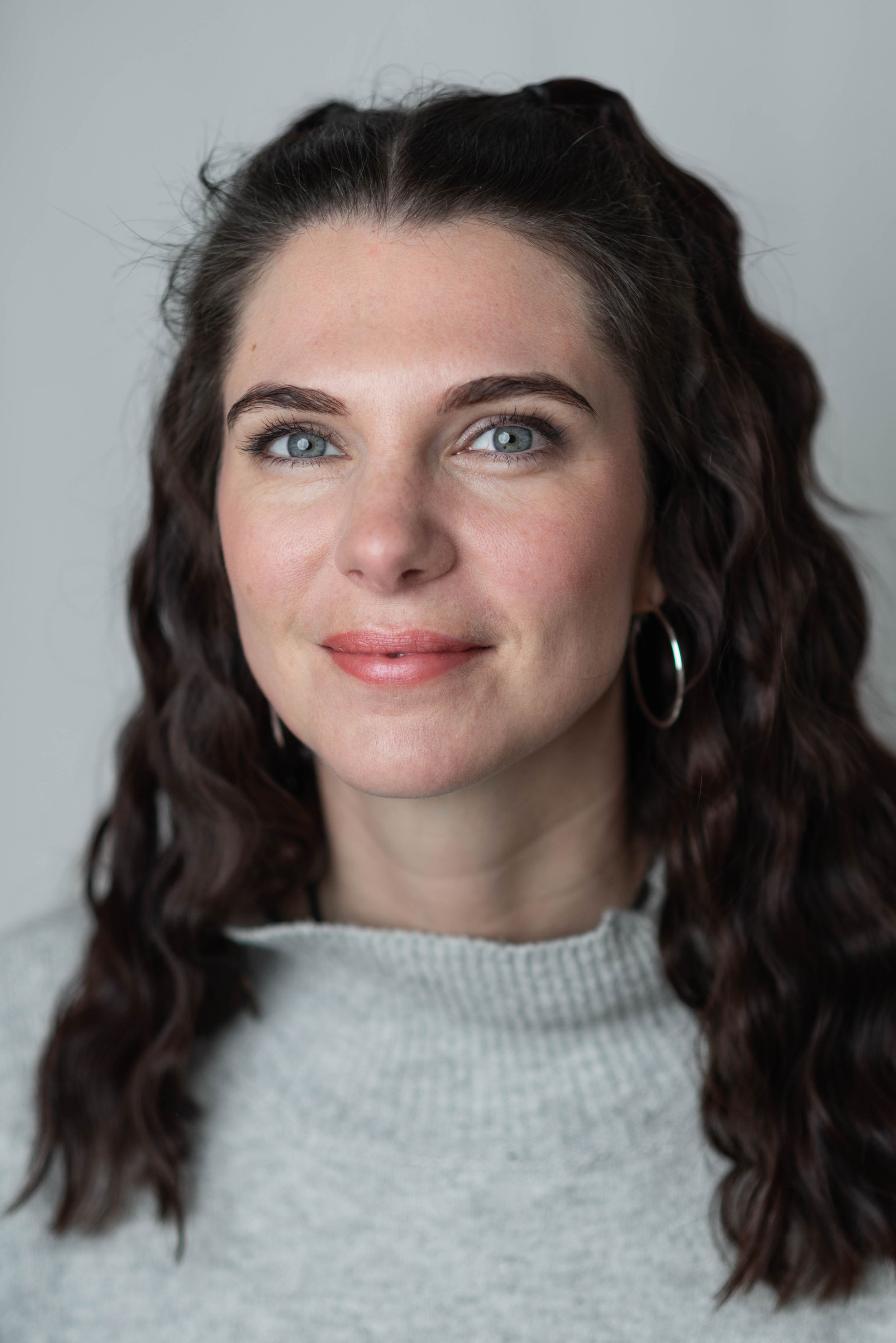 Portrait sequence in gray turtleneck showing various angles and expressions.