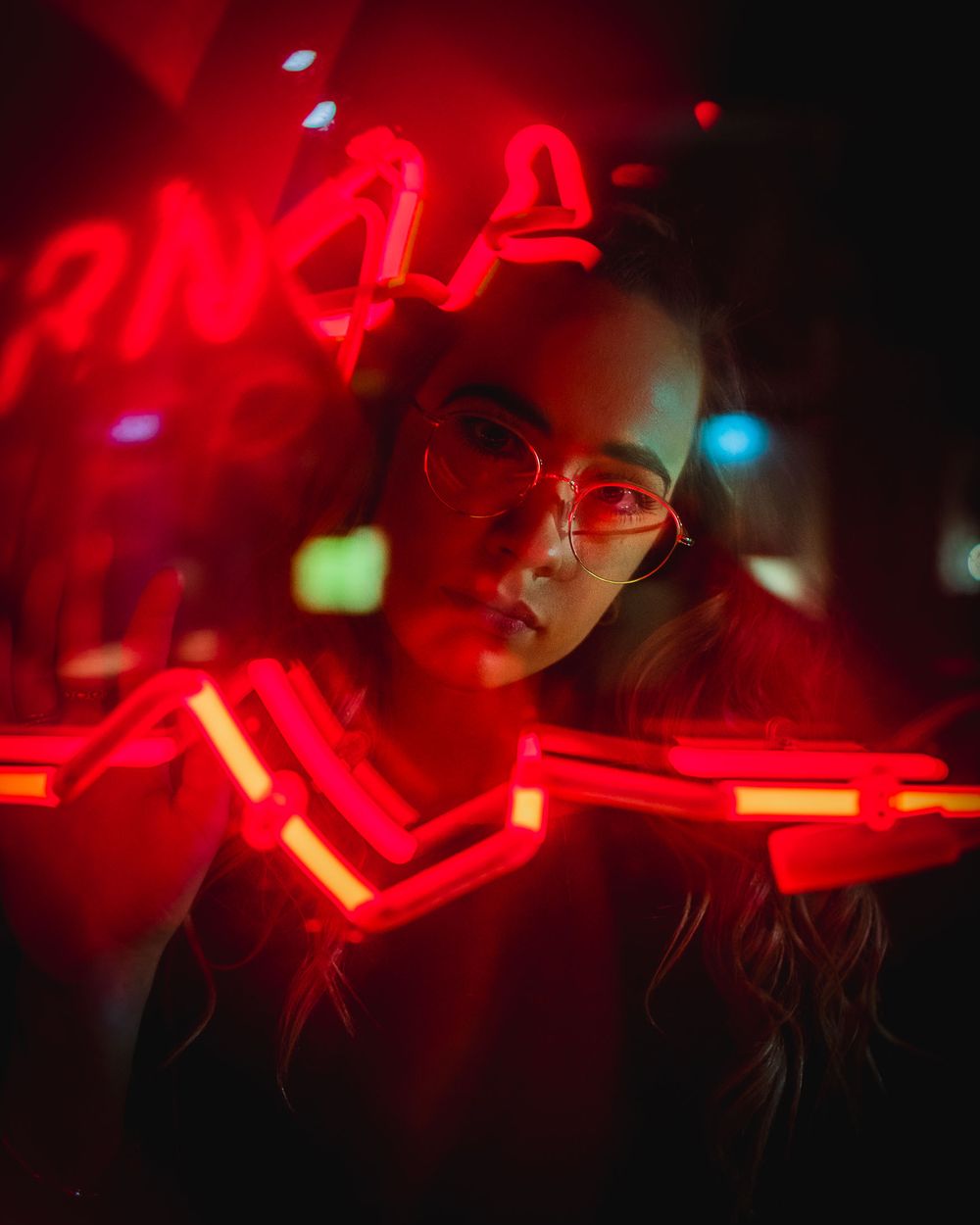 Abstract nightclub photography with red neon lighting creating a moody atmospheric effect in the darkness.