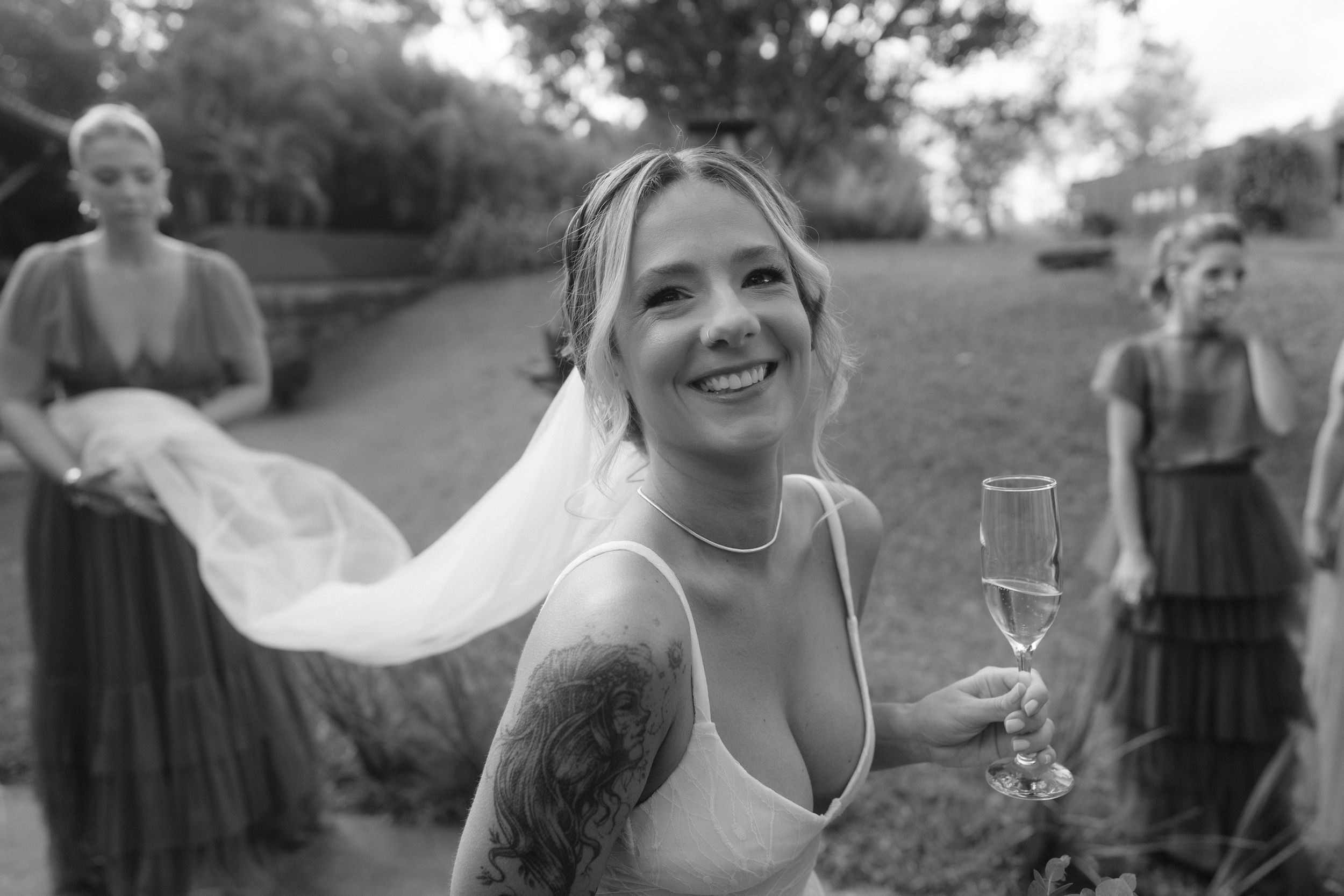 Wedding celebration captured in natural outdoor setting with guests in coordinated attire.
