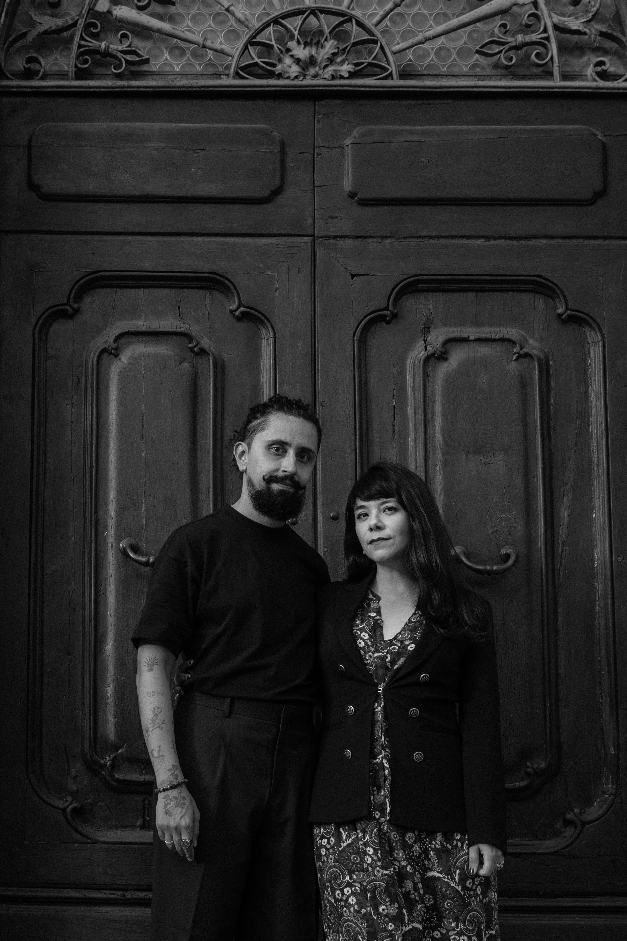 Black and white romantic couple portrait session among fallen autumn leaves.
