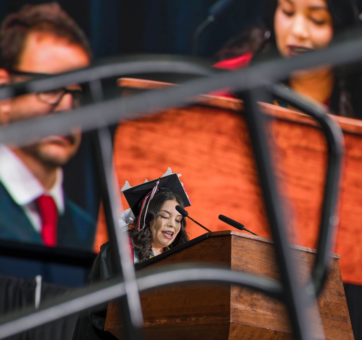 Aranxa Resendez, standing at a podium, welcomed the 2025 CHS Graduation crowd in Spanish..