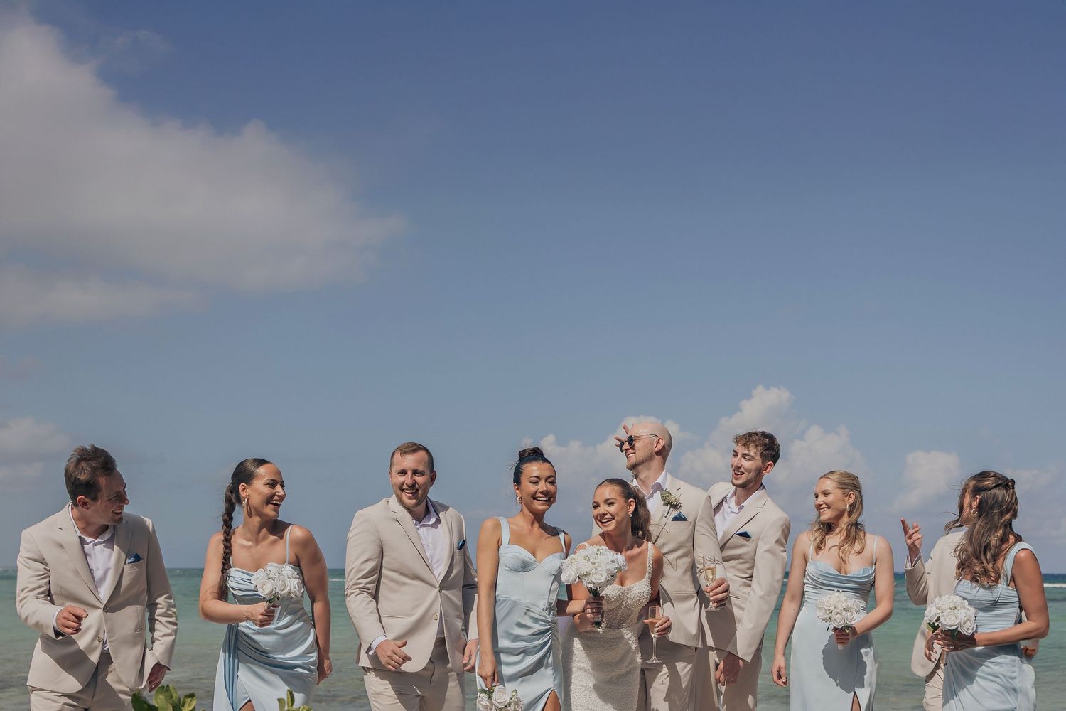 A romantic beachfront portrait of the bride and the groom during their destination wedding at Royalton Riviera Cancun.