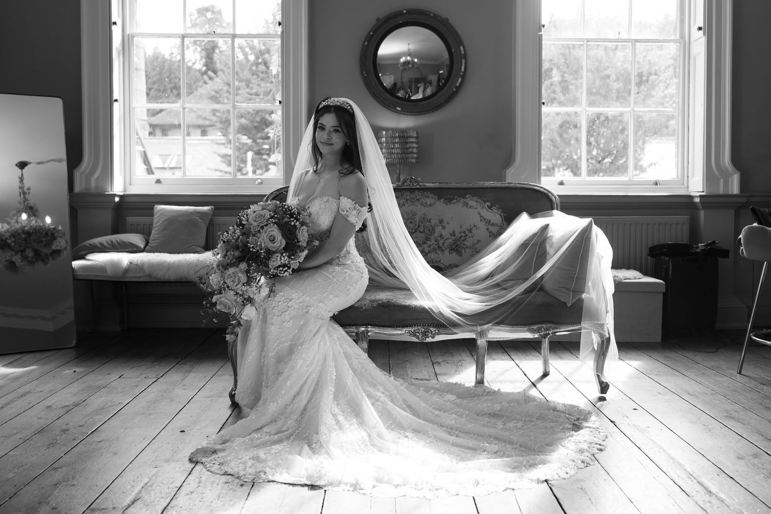 A series of black and white wedding photos showing a bride in a flowing white dress in different elegant poses.