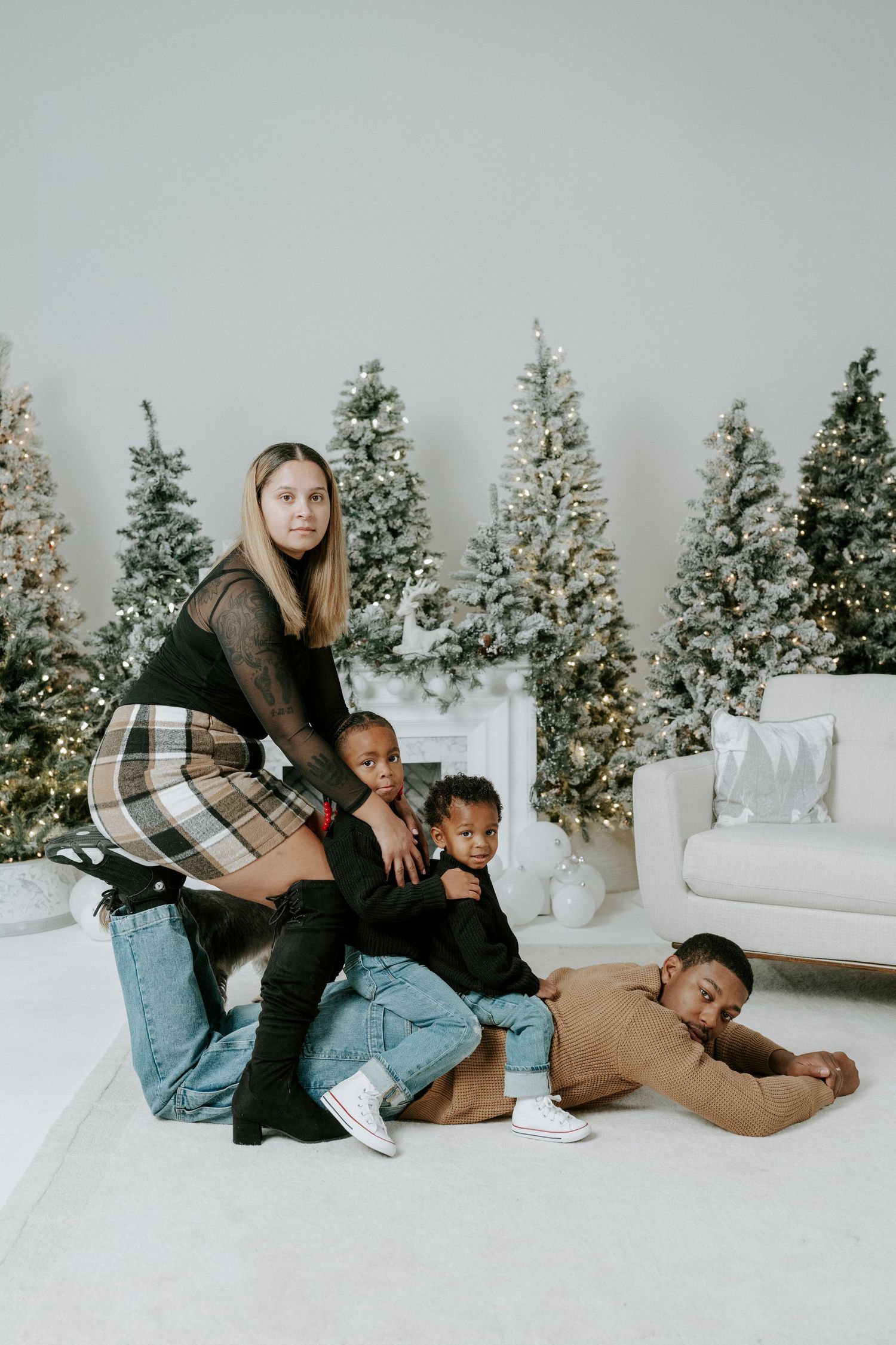 A playful sequence of four connected photos showing people relaxing together on a white couch with snowy trees in background.