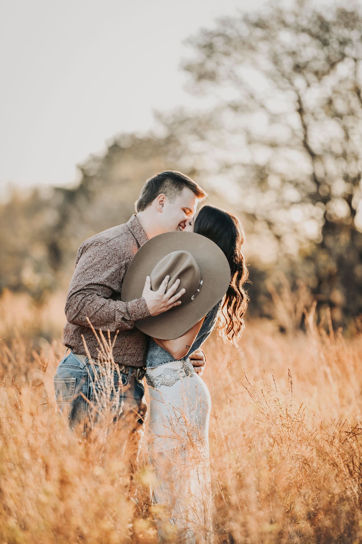 Editorial engagement photography at sunset with a couple in a rustic countryside setting