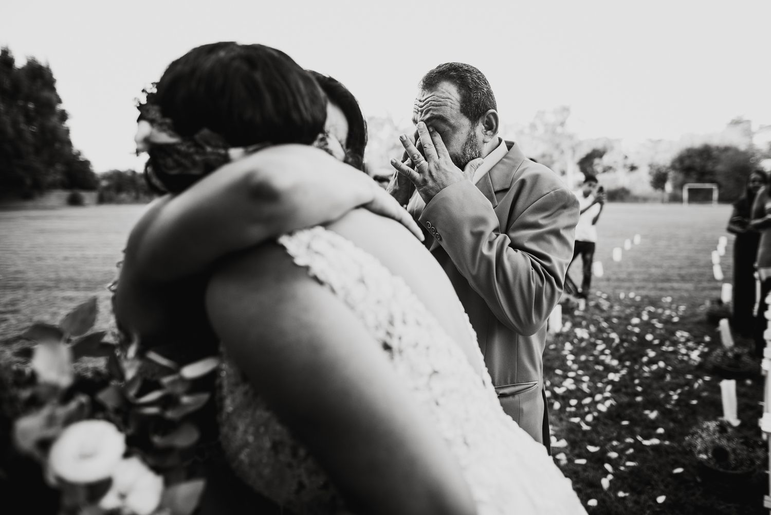Candid black and white shots of people enjoying a wedding celebration.
