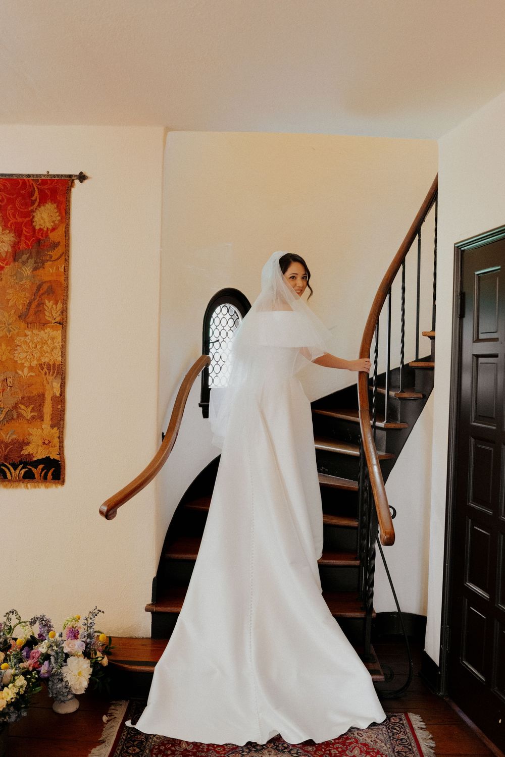 A sequence of photos showing someone in a flowing white dress twirling and dancing in a hallway with artwork on the walls.