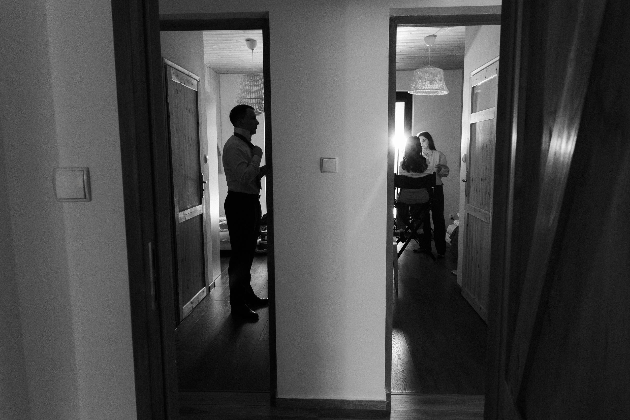 Silhouettes of people in dark hallways create an eerie atmosphere in this black and white photo collage.