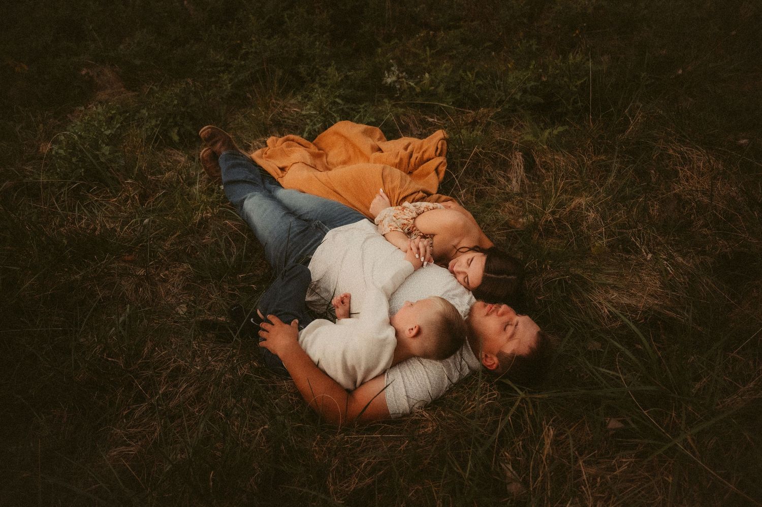 Indiana Storytelling Family Photographer // Artistic newborn photography series with baby in white lace dress lying on dark background.