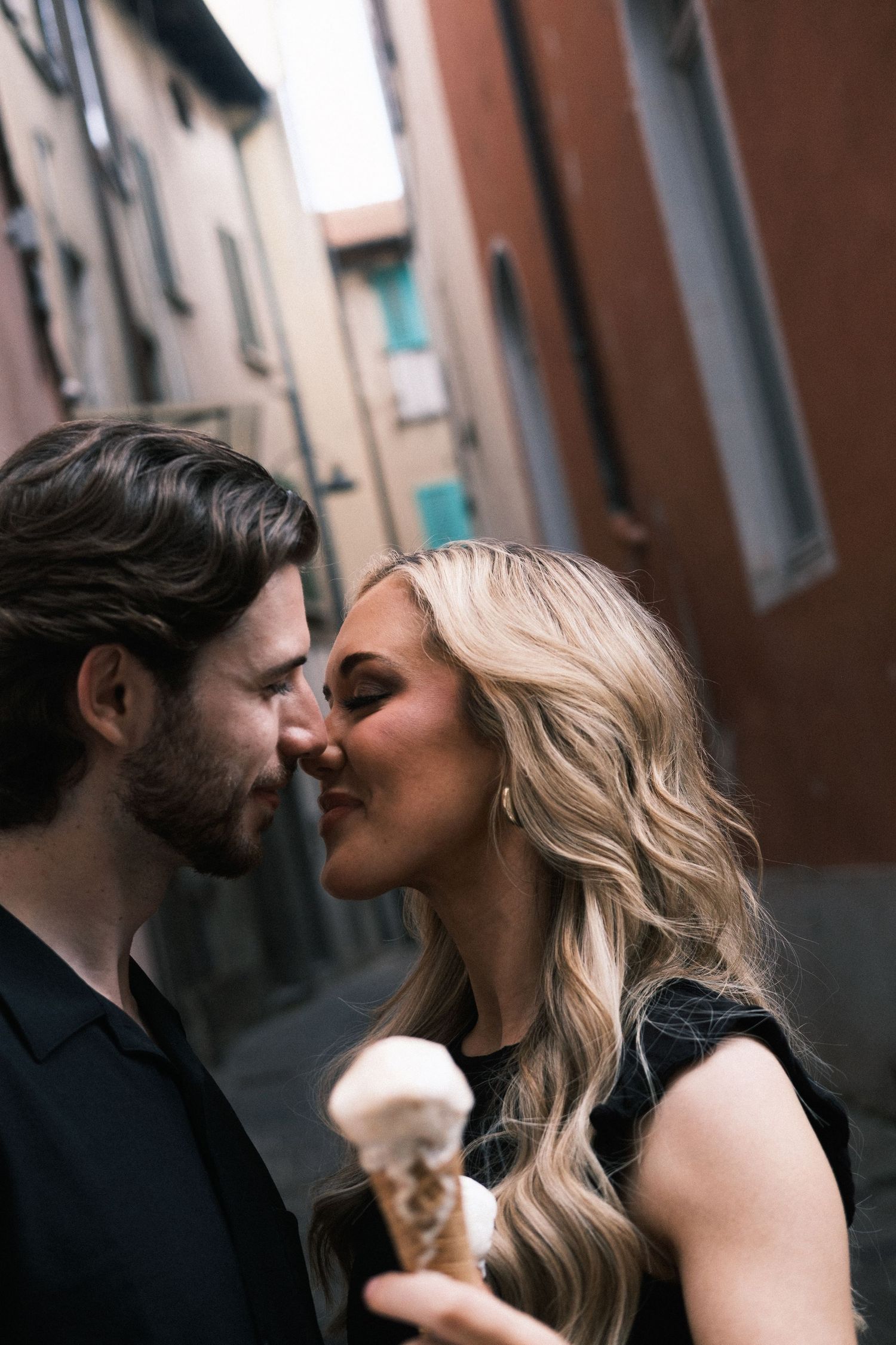 Sweet gelato kiss in picturesque Milan alleyway