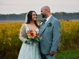 A couple shares intimate moments in a vibrant yellow sunflower field while wearing wedding attire.