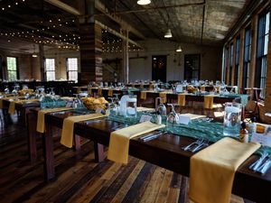 Panoramic view of a modern bowling alley interior with multiple lanes and ambient lighting creating a welcoming atmosphere.