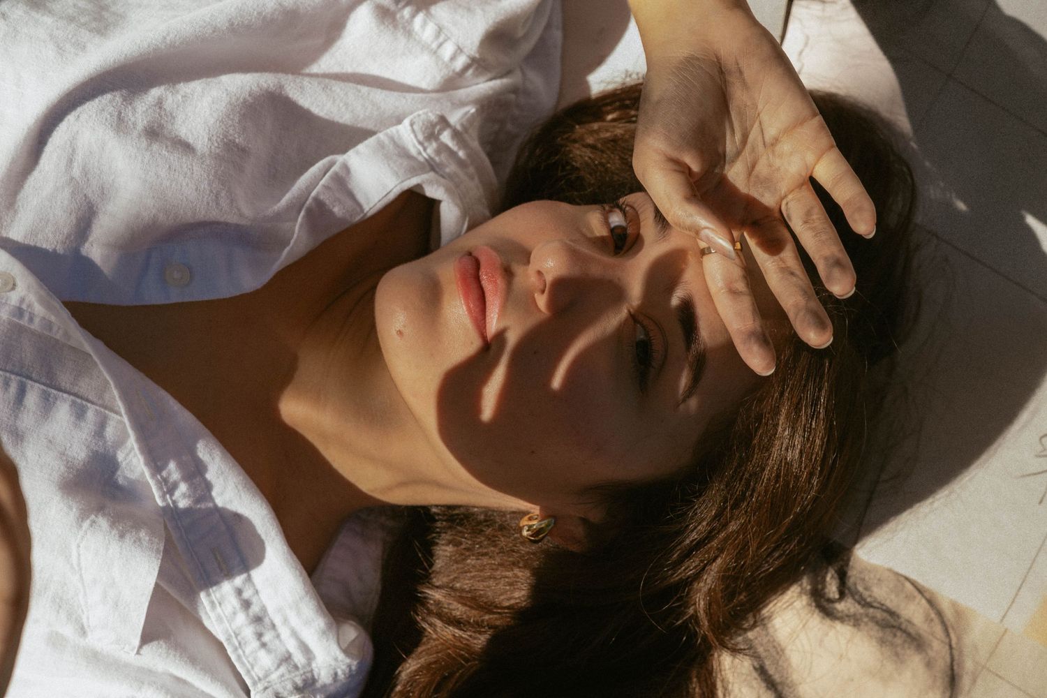 Intimate close-up portrait series with soft natural lighting and white clothing.