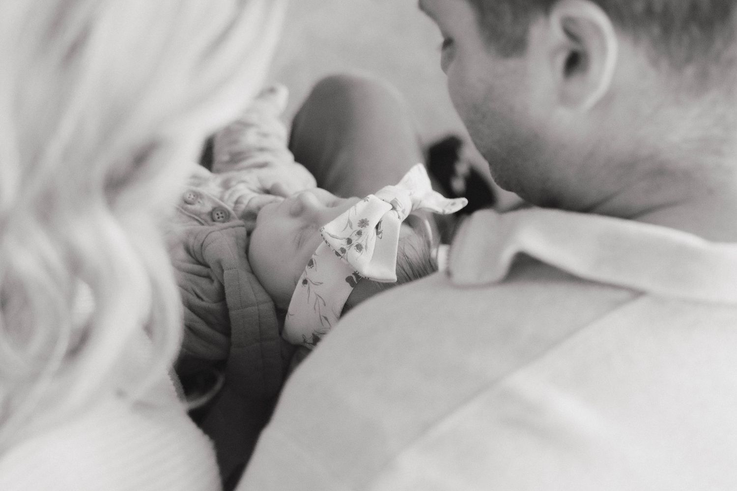 A black and white photo montage shows intimate close-up moments between a couple sharing tender kisses.