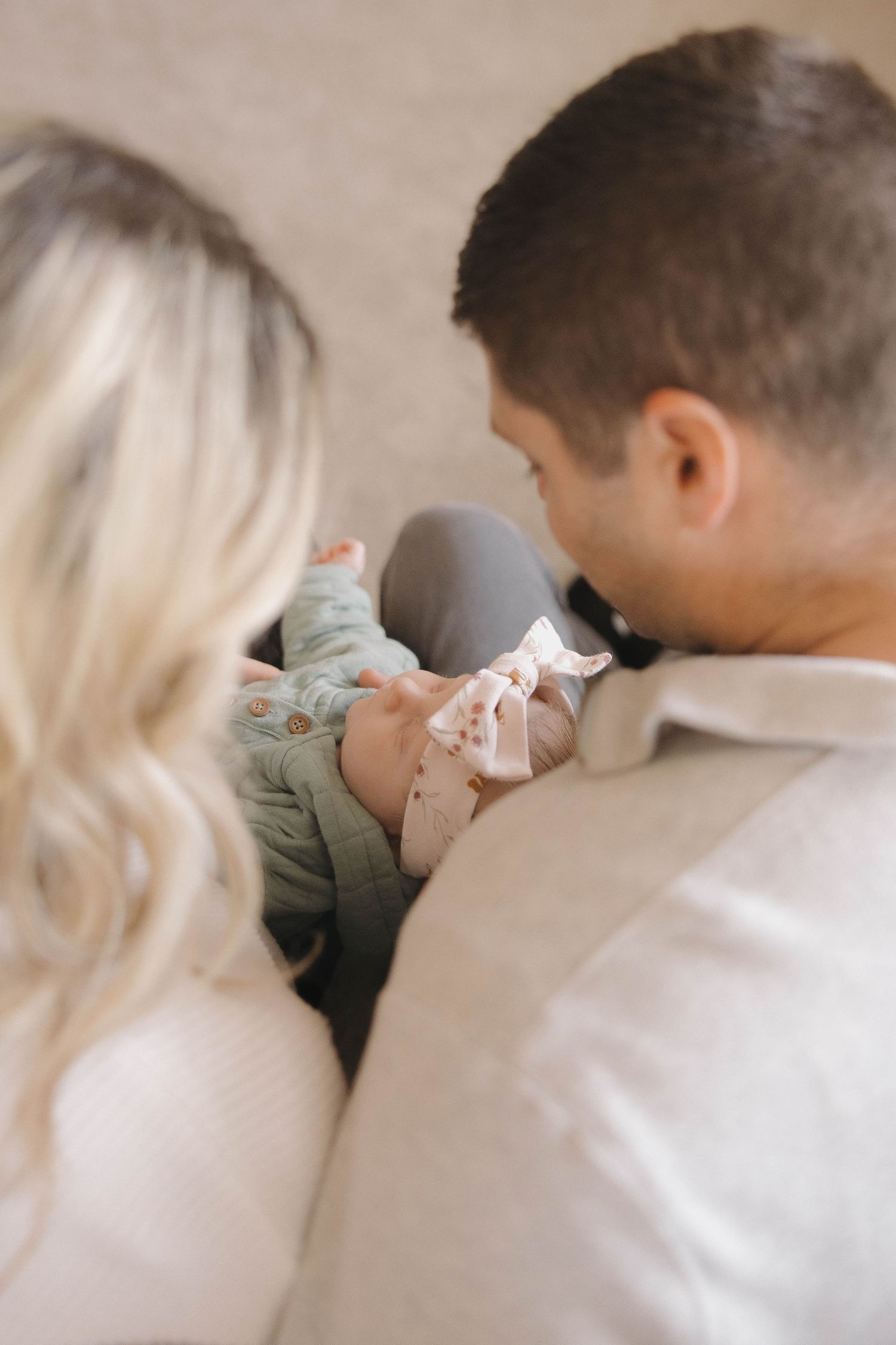 Couple in white and olive clothing sharing intimate kisses in a romantic photo series.