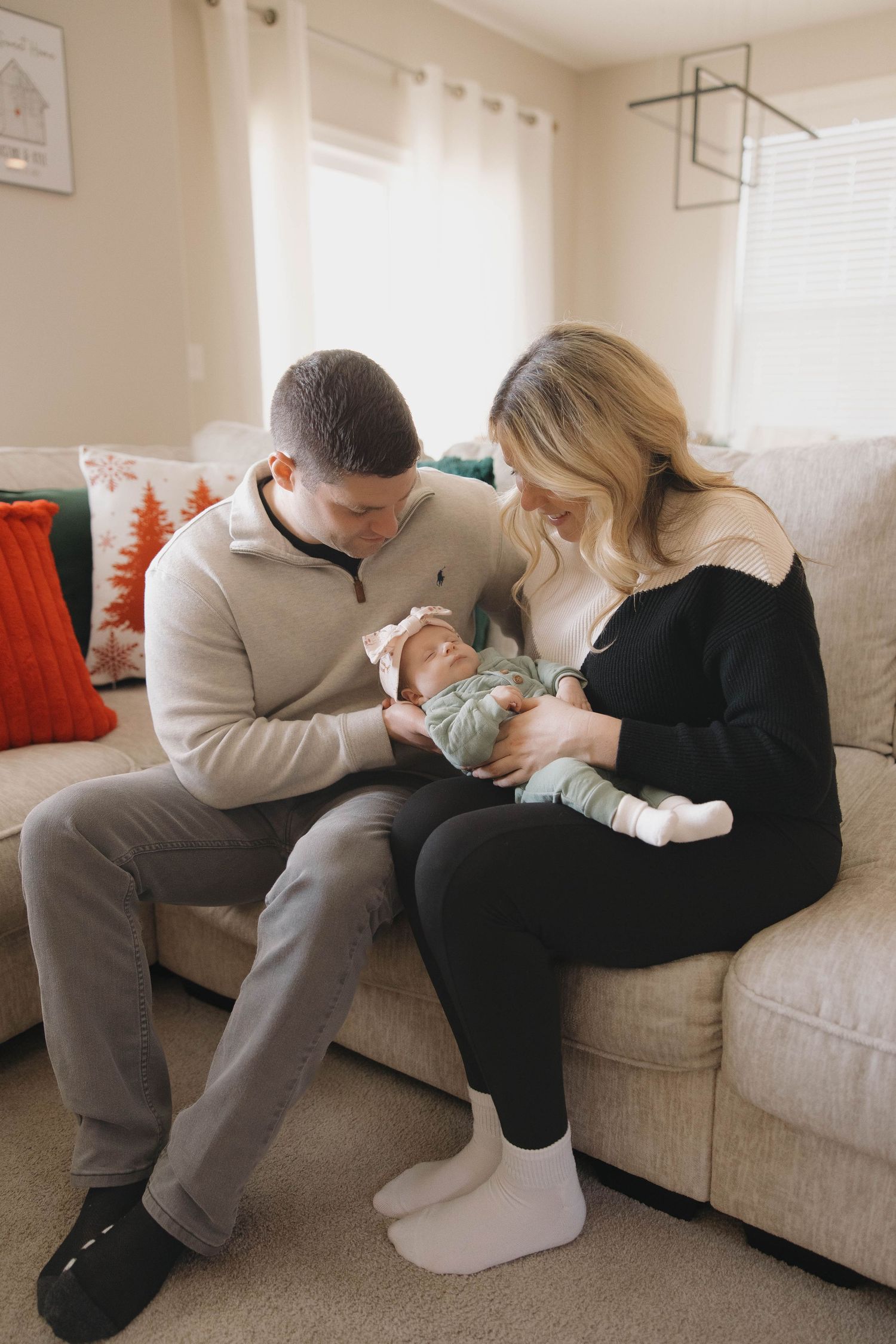 A series of tender moments shared on a light-colored couch in a bright living room.