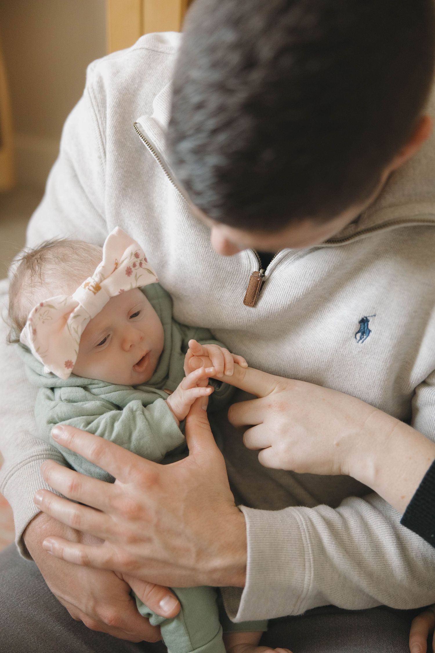 A tender moment captured showing gentle care and nurturing in soft, muted lighting.