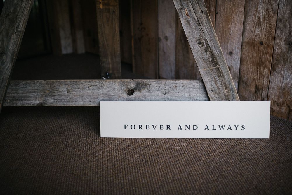 Text reading 'Forever and Always' displayed on rustic wooden background.