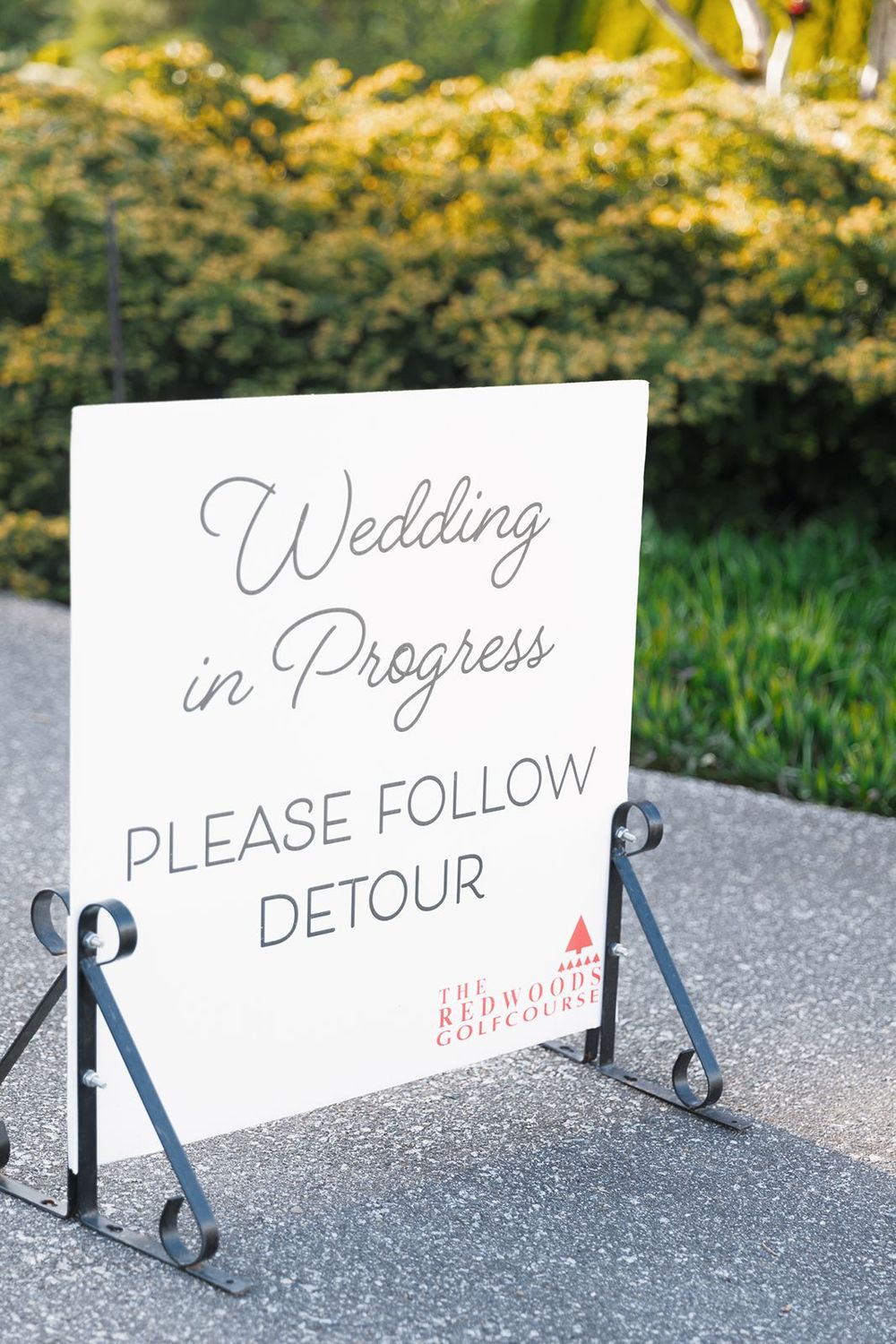 Elegant white Wedding in Progress sign with detour notice at The Redwoods Golf Course.