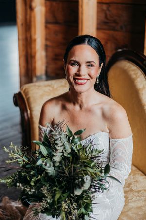 A series of elegant bridal portraits showcasing a lace wedding dress and lush greenery bouquet in a rustic wooden setting.