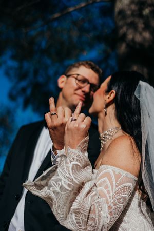 Close-up sequence of intimate wedding moments showing details of lace sleeves and tender expressions.