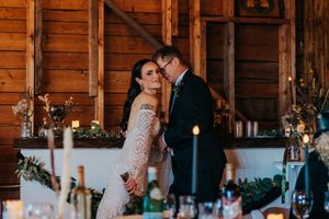 Rustic barn wedding venue decorated with romantic candlelight and wooden beams.