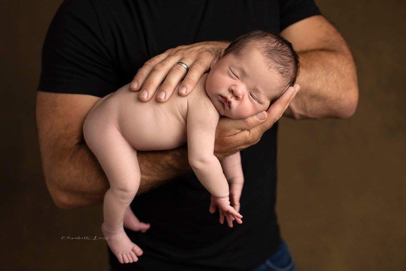 A series of black and white photos showing tender moments between a parent and newborn baby.