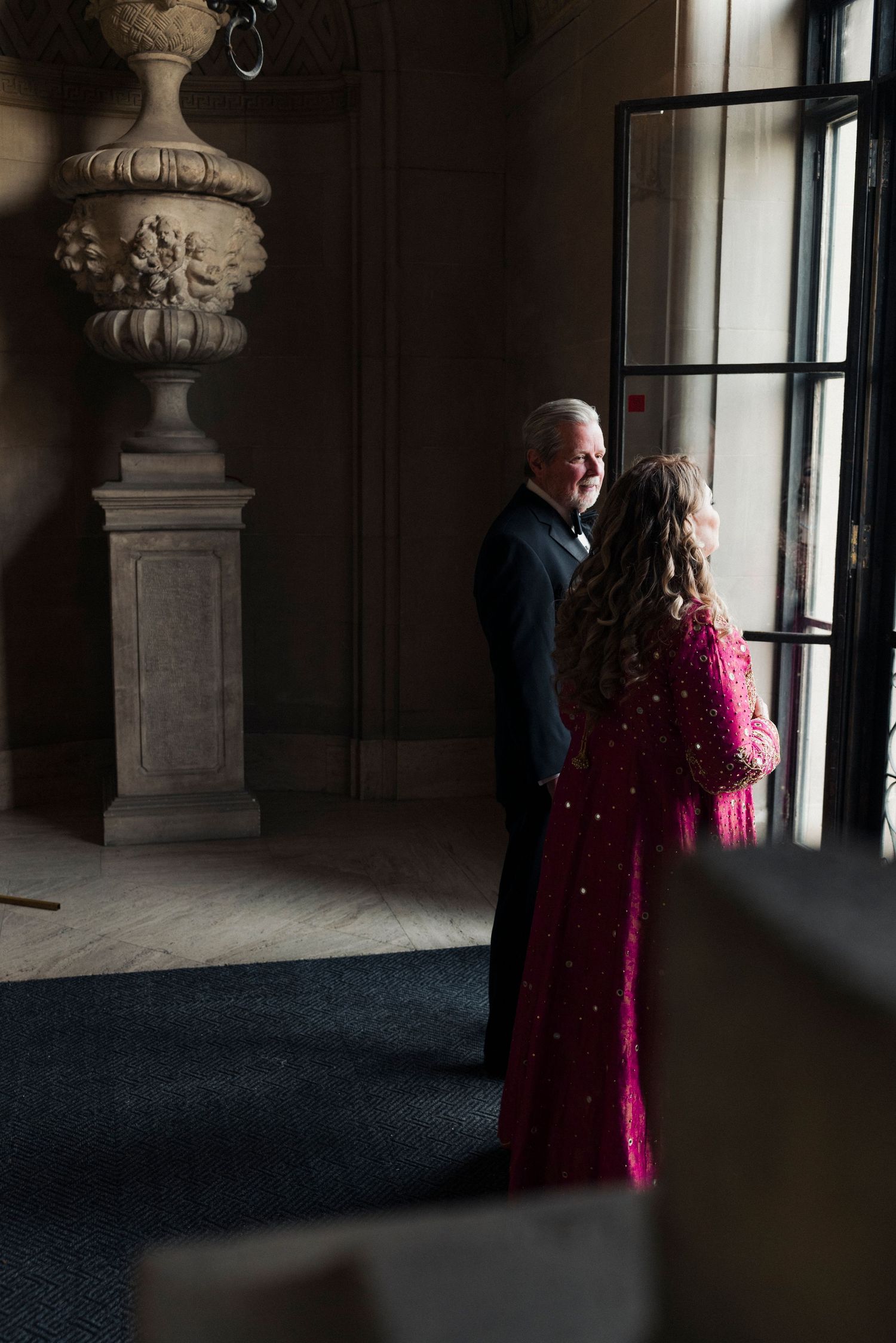 First look between a bride and her parents at Cuneo Mansion entrance.
