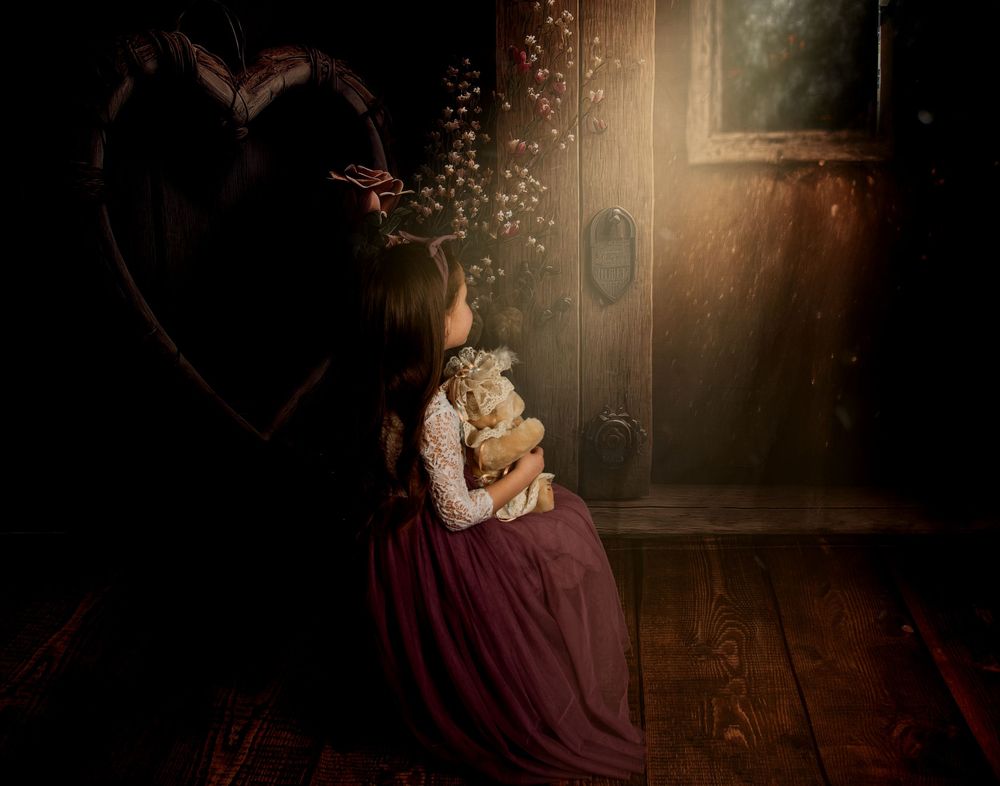 A moody and romantic photo series showing intimate moments between a couple in burgundy attire against dark backgrounds.