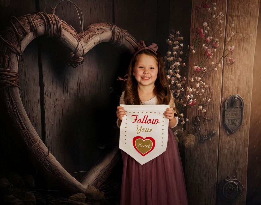 A collection of Valentine's themed photos with a heart sign and burgundy dress against a rustic wooden background.