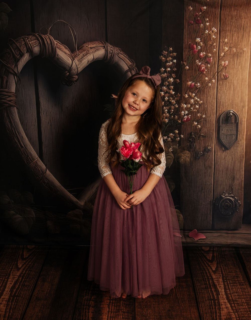 Whimsical photo series with burgundy tulle dress in front of dark wooden panels with delicate floral accents.