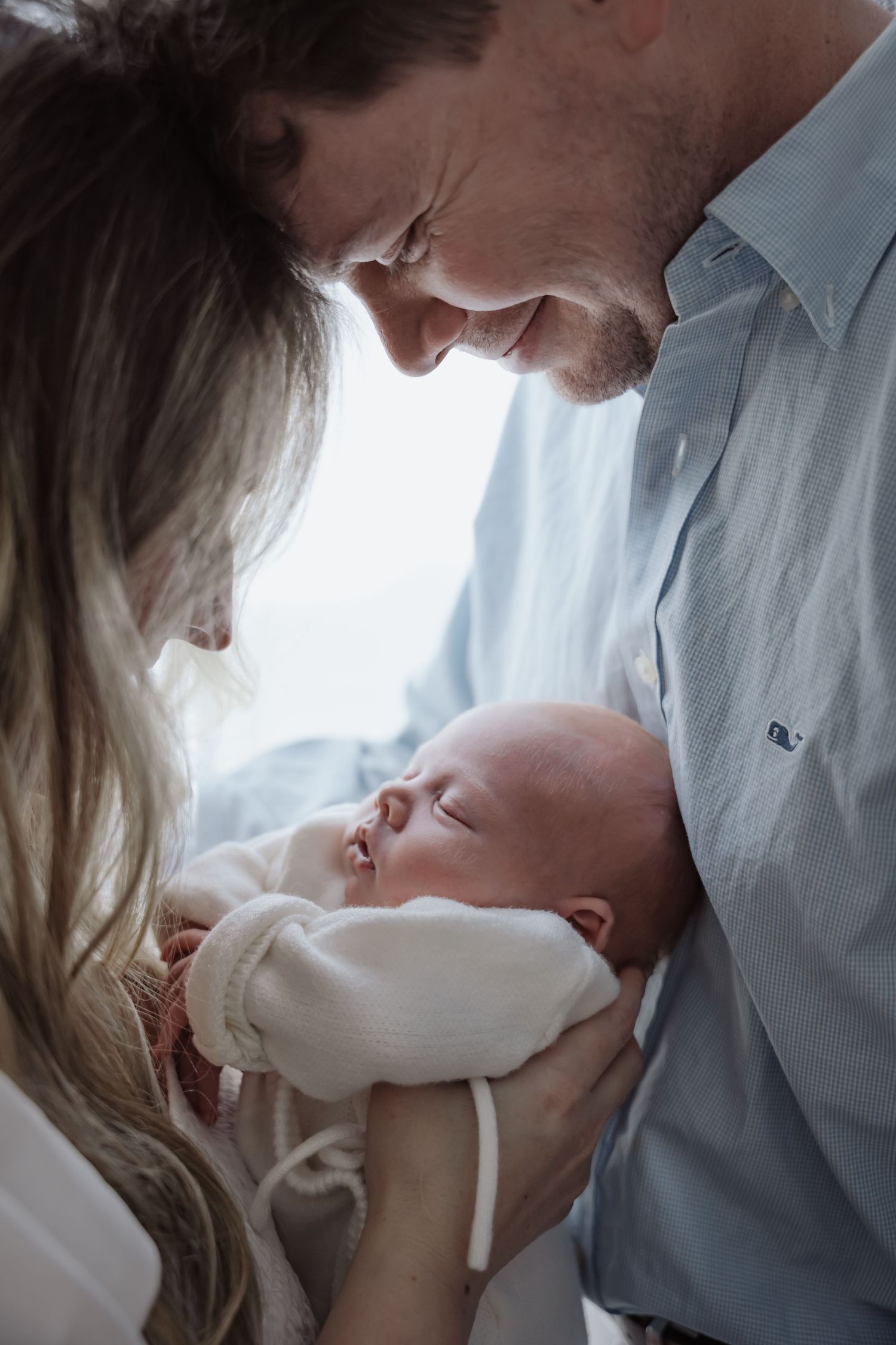 Parents share an intimate moment with their newborn baby in a series of tender close-up photographs.