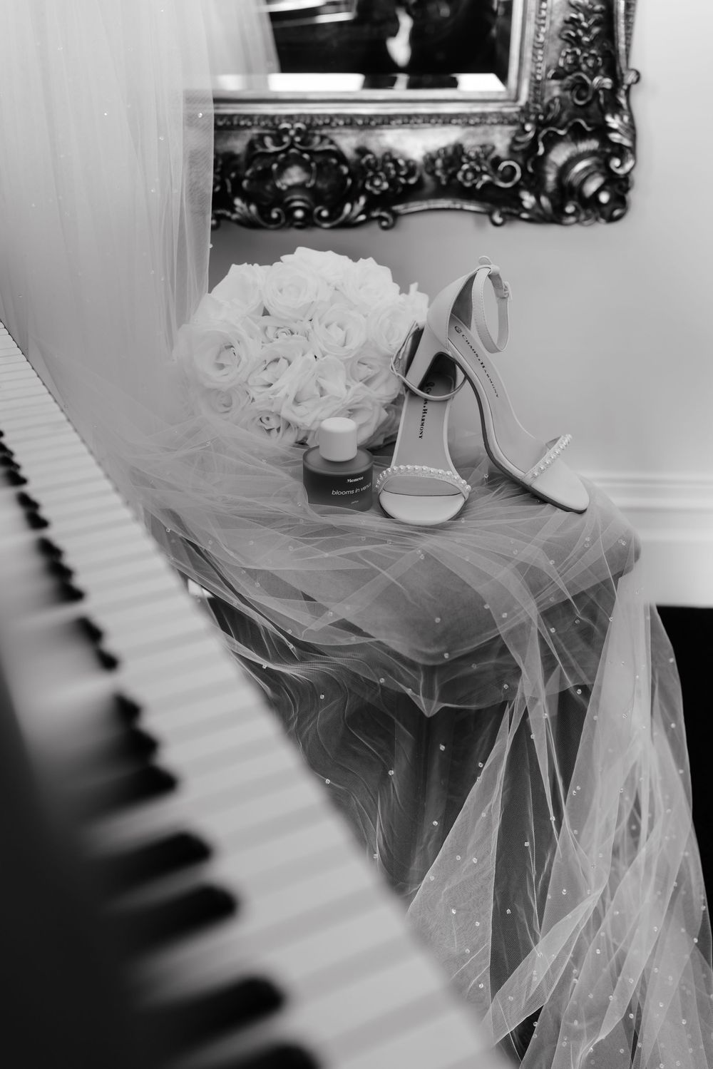 Piano keys and wedding veil create an elegant black and white composition.