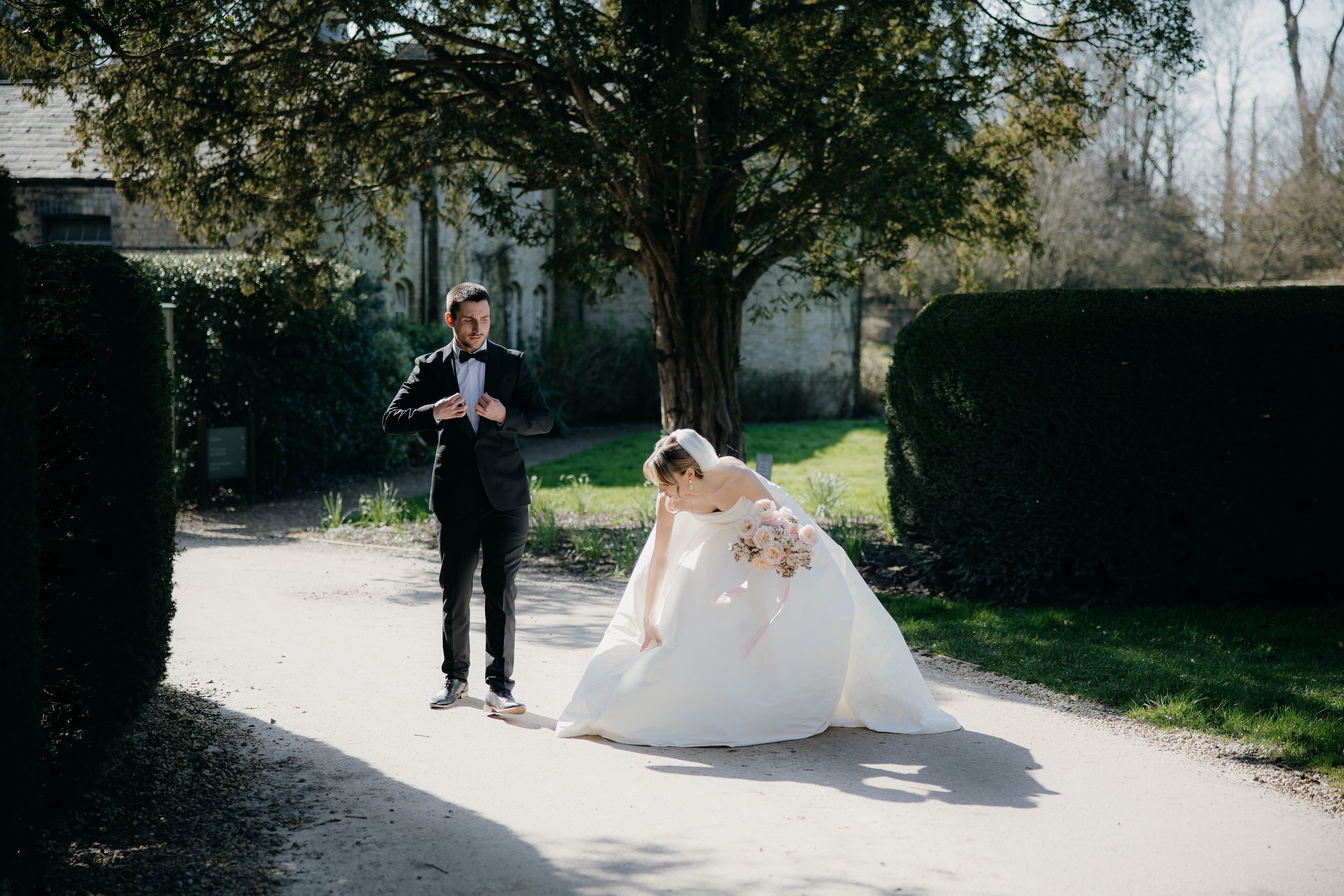 A wedding couple walks together through a garden path on their special day, captured in a romantic sequence.