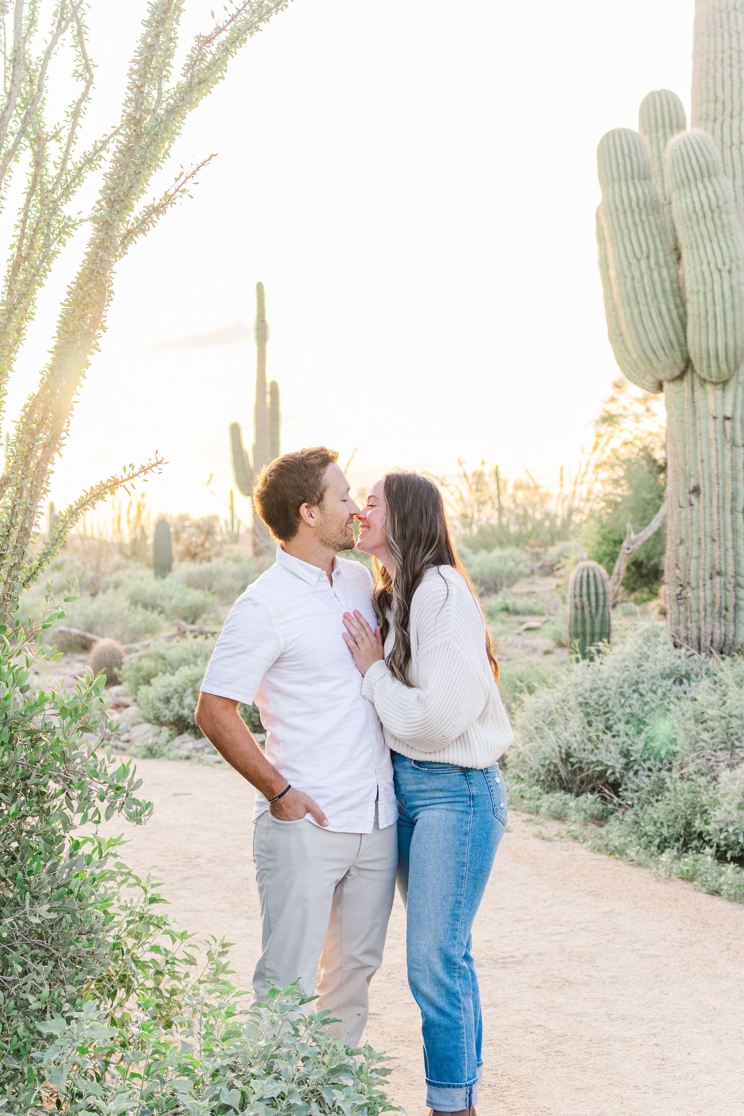 married couple leaning in for a kiss at golden hour in the desert