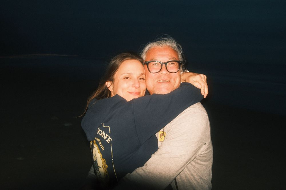 A series of six dimly lit photos showing people embracing in emotional moments.