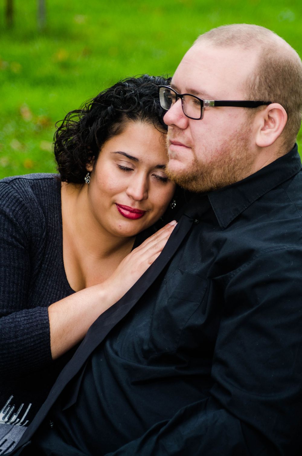 A romantic couple shares tender moments outdoors with a green background in a series of intimate portraits.